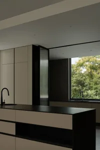 Modern kitchen featuring concrete, glass, metal, and wood elements