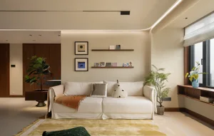 A modern living room featuring neutral-toned furniture and minimalist decor.