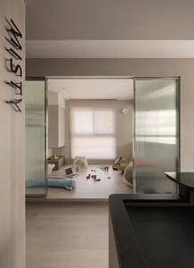 A modern residential playroom featuring wooden flooring, steel furniture, and glass doors.