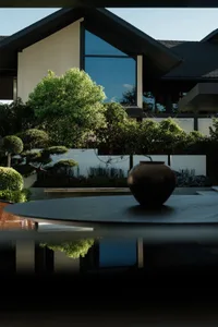 A modern residential exterior featuring large glass windows, stone accents, and wooden elements.