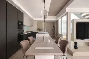 A modern residential kitchen featuring black and white interior design elements, with a long wooden dining table and minimali