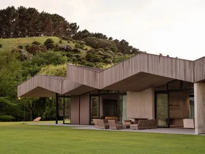 A modern residential building with a metallic exterior features contemporary architectural design.