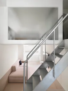Minimalist design featuring a metal staircase with a sleek, modern aesthetic.