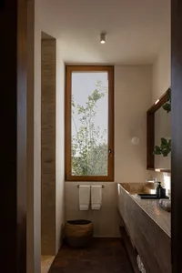 Bathroom interior with modern design, stone construction, and natural light.