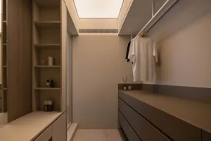 A minimalist closet interior with wood and laminate materials.