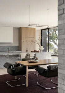 A modern interior space featuring a stone floor and table.