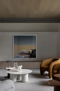 Modern living room with minimalist design, wooden elements, and plush seating.