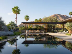 Modern residential outdoor space featuring concrete, glass, and metal materials.