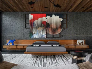 Industrial-themed bedroom featuring a floating bed with wooden accents and a bold, abstract wall art piece on the dark wall.