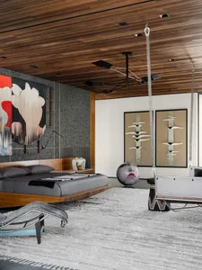 An industrial-style bedroom featuring a metal frame bed, glass elements, and modern decor.