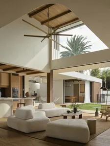 A minimalist living room with wood elements and a white color scheme.