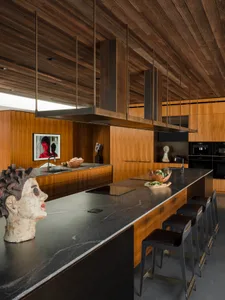 Modern kitchen interior with wooden ceiling and marble countertop