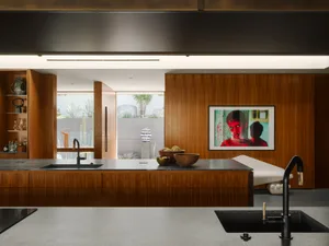 Contemporary kitchen featuring wooden cabinets and stone countertops