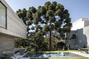 A modern landscape design featuring concrete structures and natural elements.