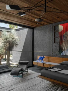 Modern minimalist bedroom featuring wood and glass elements with a blue dog statue on the bedside table and a plush rug on th