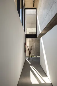 A modern minimalist interior with concrete walls and floor.