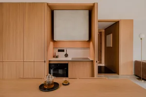 A modern minimalist kitchen with wooden cabinets and a minimalist design.