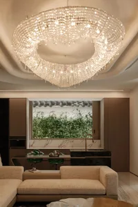 A modern living room featuring a metal chandelier hanging from the ceiling.