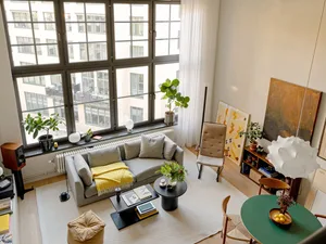 Contemporary living room with modernist furniture and plants.
