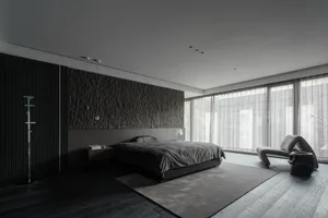A minimalist bedroom featuring dark wood floors, stone accent wall, and glass walls with a bed and wooden furniture.