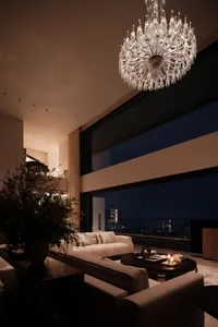 Modern apartment space featuring a glass wall with a city view.