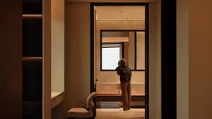 A minimalist modern bathroom with metallic surfaces and sleek, simple design.