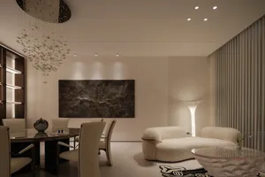 Contemporary dining and living room with white furniture, abstract art, and modern lighting