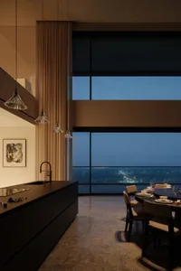 A modern kitchen with a glass ceiling and large windows overlooking a cityscape.