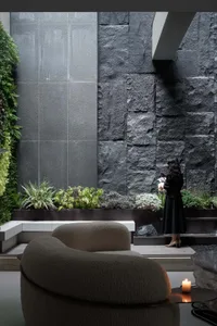 Modern living room featuring a sleek, minimalist design with concrete, glass, and metal elements.
