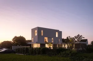 Modern minimalist house with concrete and glass exterior at dusk