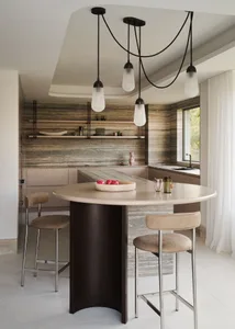 Modern minimalist kitchen with marble countertops and stainless steel appliances.