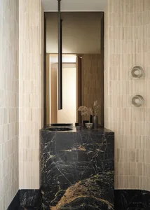 A modern bathroom featuring a black marble countertop and ceramic tiles.