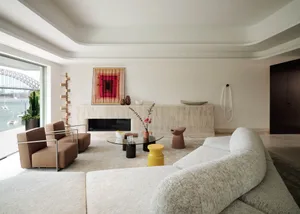 A modern living room featuring concrete and glass materials.
