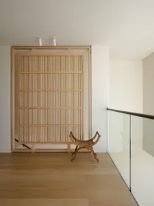 Modern minimalist living room with wooden accents and wooden furniture, designed for a comfortable and stylish living space.
