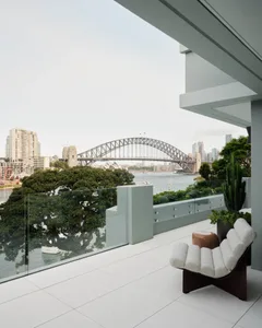 A modern balcony overlooking the city with glass railings.