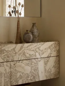 Modern marble console table with artisanal ceramic vases and dried flowers