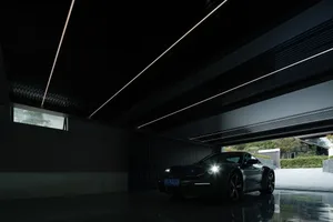 A sleek, metallic modern garage interior with a reflective floor and contemporary design elements.