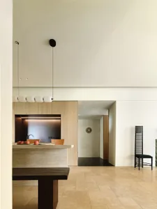 Modern kitchen featuring dark and light natural stone countertops and backsplash, with a minimalist design and sleek lines.