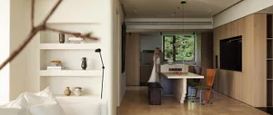 Modern living and dining room with marble counter and wooden furniture, showcasing a contemporary design aesthetic.