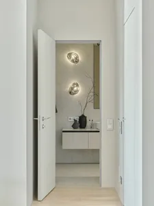Modern bathroom featuring marble and concrete finishes with minimalist design and sleek fixtures.