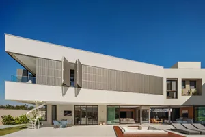 Modern residential building with concrete and glass materials.