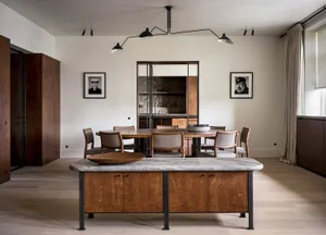 A modern residential dining area featuring wood and stone materials.
