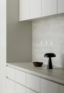 A minimalist interior space featuring a concrete countertop and cabinets.