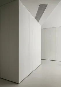 A minimalist interior space with white panels covering the walls.