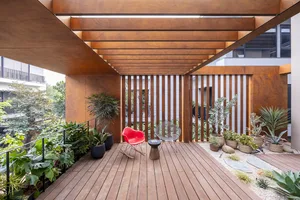 A minimalist space with wood flooring and slatted wood wall and ceiling.
