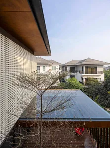 Modern house with metal exterior and tree in foreground