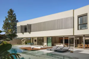 Modern residential home with concrete exterior and large open living space.