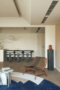 Modern minimalist residential interior with wooden furniture, marble accents, and leather textures.