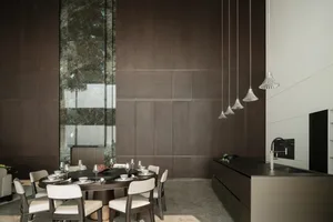 Modern dining room featuring wooden flooring, a large window, and a sleek, minimalist design.