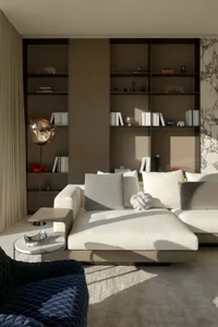 A modern living room featuring a white couch and contemporary furniture.